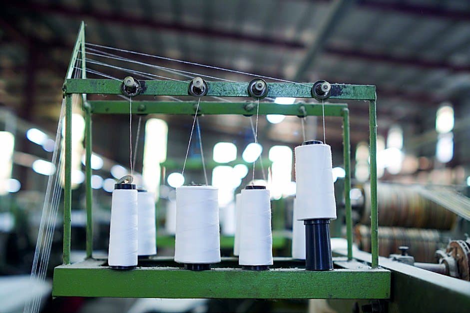 Workers operating power looms